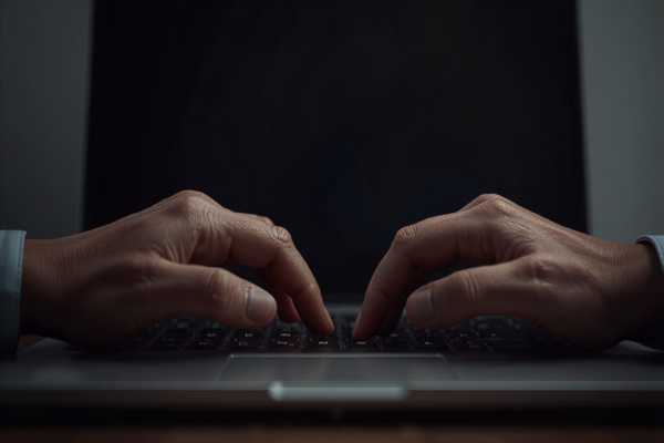 Hands typing on a laptop representing online case access and eFiling