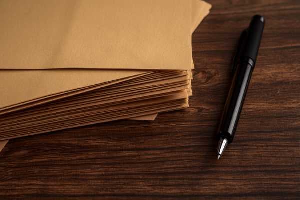Stack of legal folders with a calculator and pen